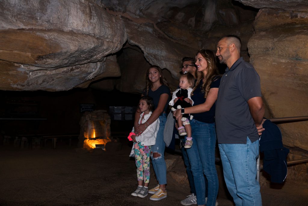 six people learning about the history of cave structures underground in Colorado Springs