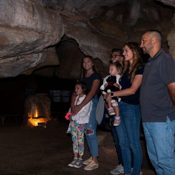 six people learning about the history of cave structures underground in Colorado Springs